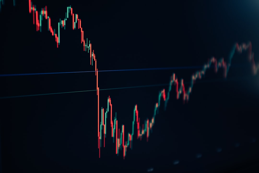 candlestick stock chart on dark screen